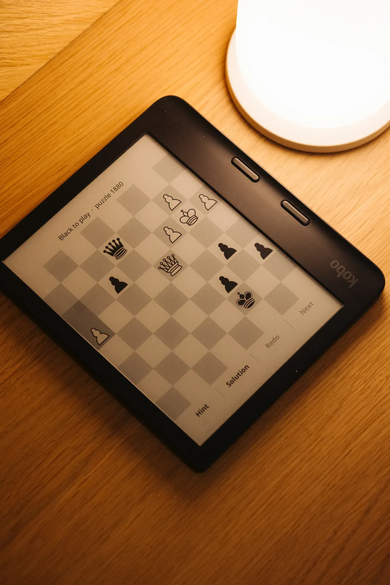 Kobo on the nightstand showing a Lichess puzzle